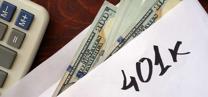 401k cash in envelope and calculator.