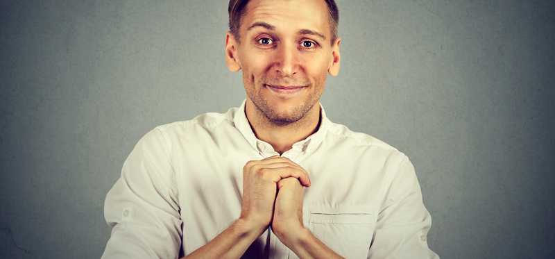 Man has his hands folded in front of him as if asking for a favor.