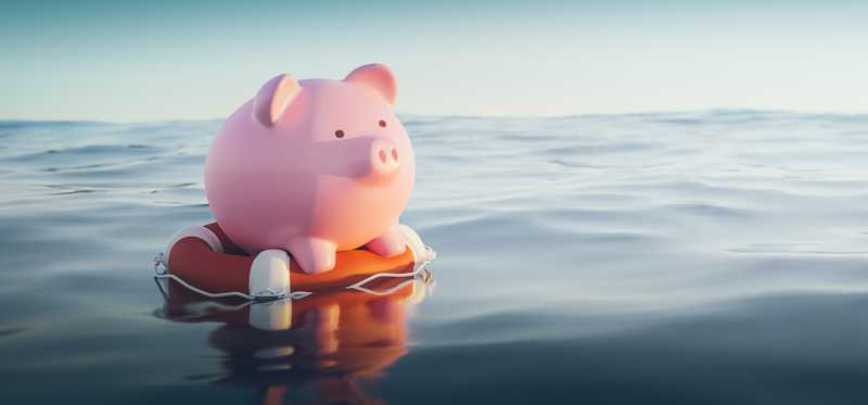 Piggy bank on a life preserver in open water.