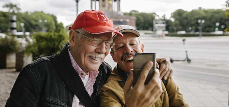 Two people take selfie outside while traveling.