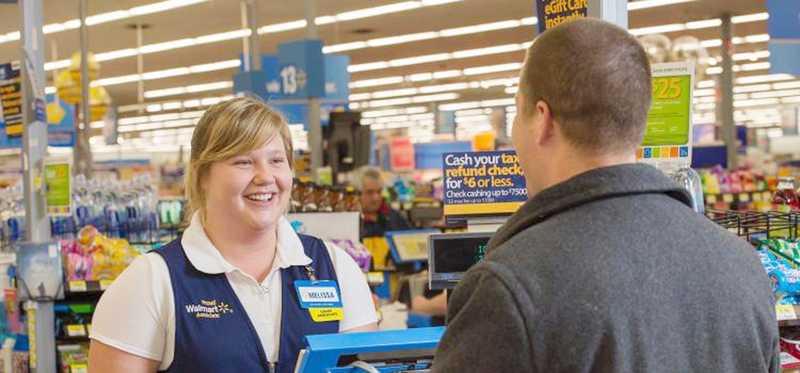 A Walmart clerk helping a customer.
