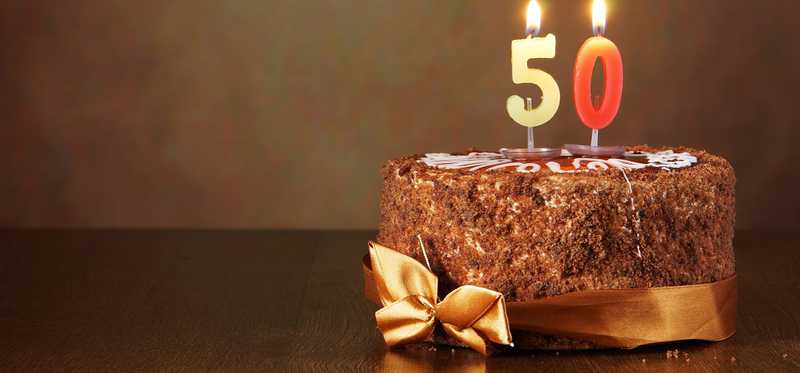 A birthday cake with candles numbered 5 and 0.