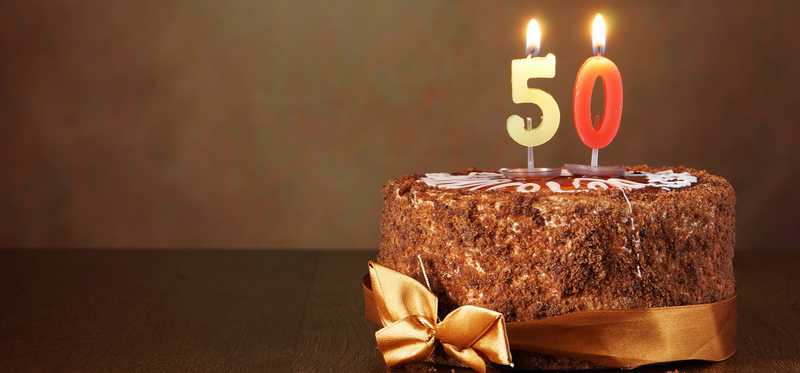 A birthday cake with candles numbered 5 and 0.