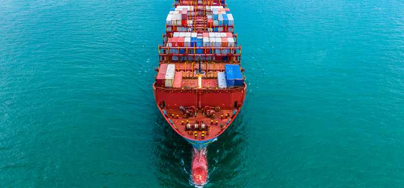 A shipping barge loaded with metal shipping crates.