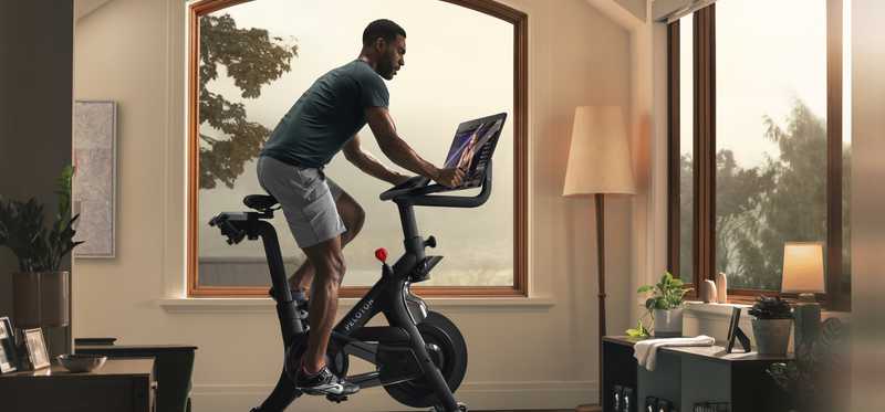 Person riding a Peloton bike.