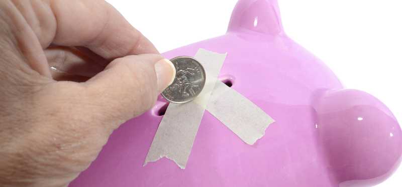 Piggy bank sealed with tape blocks coin contribution