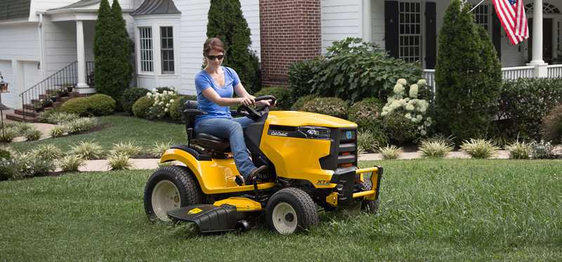 Person riding a Cub Cadet riding mower.