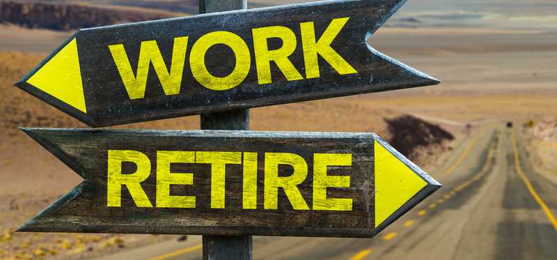 Two road signs, one pointing to Work and the other to Retire.