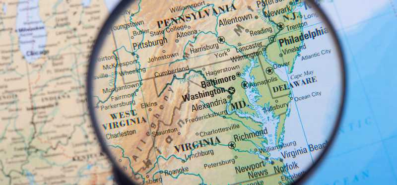 Magnifying glass on a map over Maryland.