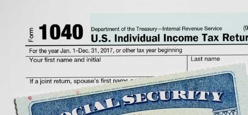A Social Security card atop a 1040 tax form.