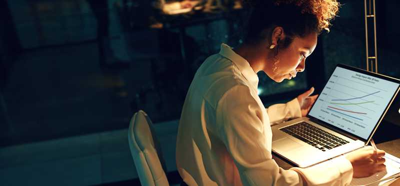 Person working in dimly lit office.