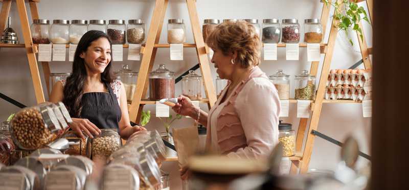 A shopper and a clerk in a small upscale shop.