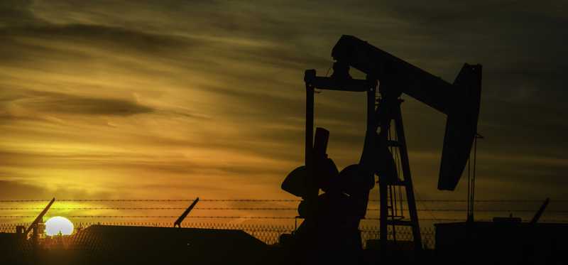 Oil rig drilling in the sunset.