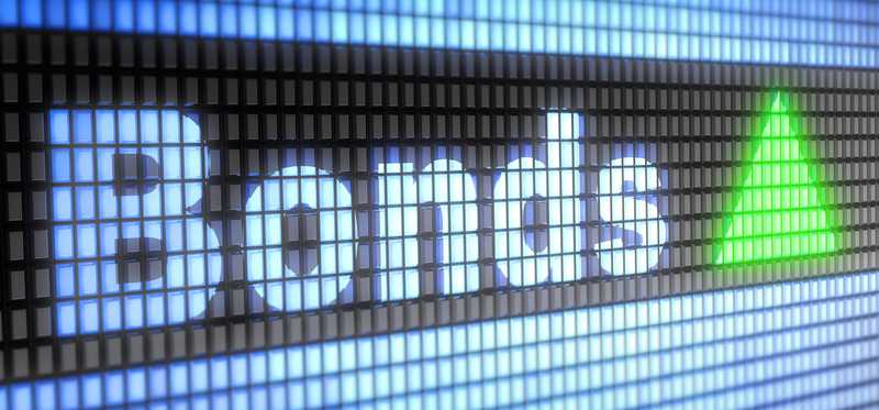 The word Bonds with a green upward facing triangle on a digital screen