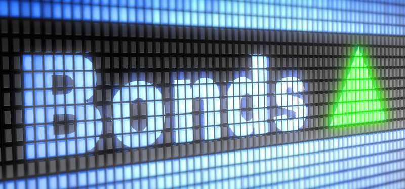 The word Bonds with a green upward facing triangle on a digital screen.