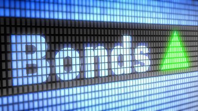The word Bonds with a green upward triangle on a digital screen.