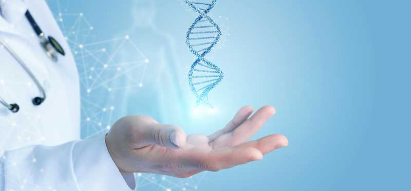 Person in white labcoat holds out hand with a virtual DNA double helix floating above it.