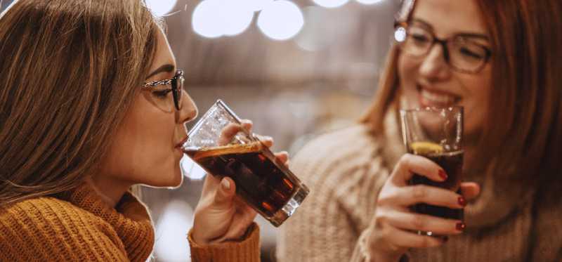 Two people drinking sodas.