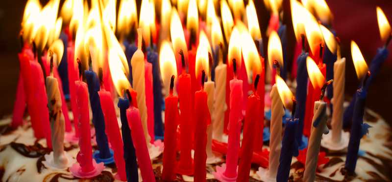 A cake jam packed with lit birthday candles.