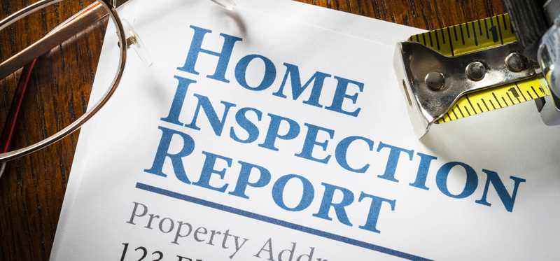 A closeup of a document that says Home Inspection Report.