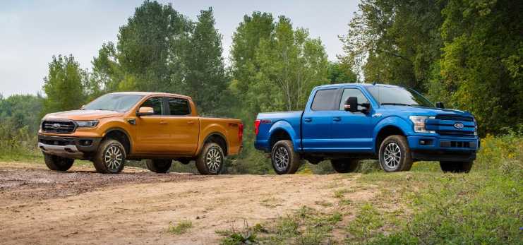 A 2019 Ford Ranger and F-150 parked next to each other on a dirt road.