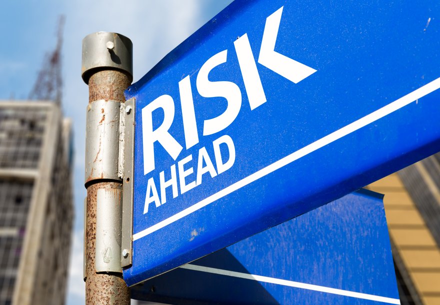 A blue sign reading risk ahead.