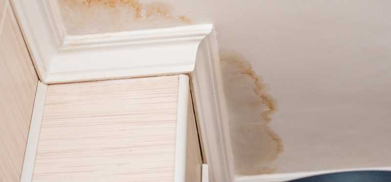 A ceiling with water damage stains.