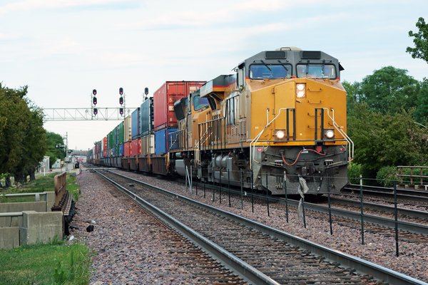 A freight train traveling down the railroad tracks.