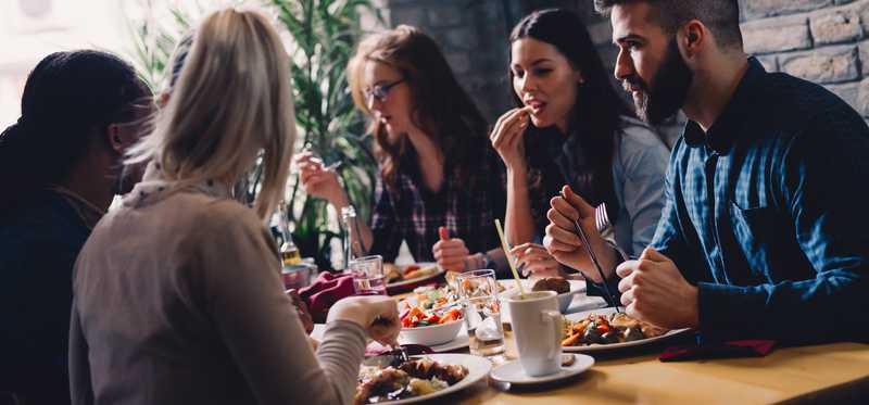 A group of people eating dinner at a casual-dining restaurant.