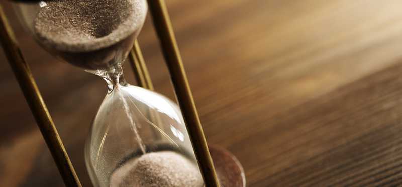A half-emptied hourglass on a table