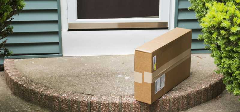 A package sitting in front of the door of a home.
