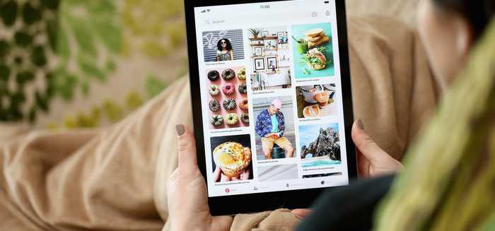 A person browsing pinned interests on a tablet.