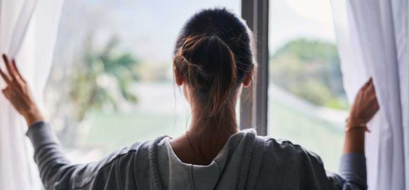 A person looking out a window.