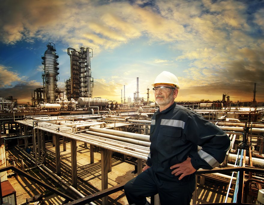 A person standing next to an energy facility.