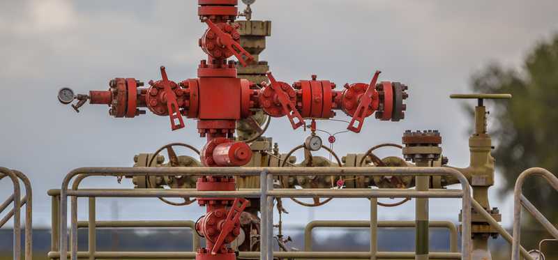 A red natural gas wellhead.