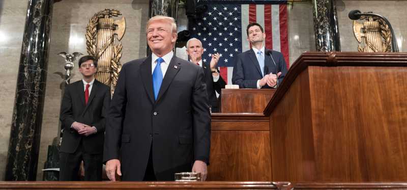 A smiling President Trump stands ready to deliver State of the Union address.
