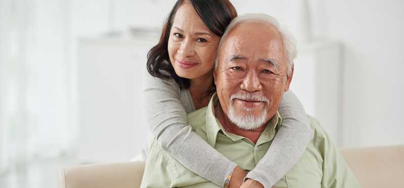 A smiling senior couple embracing each other