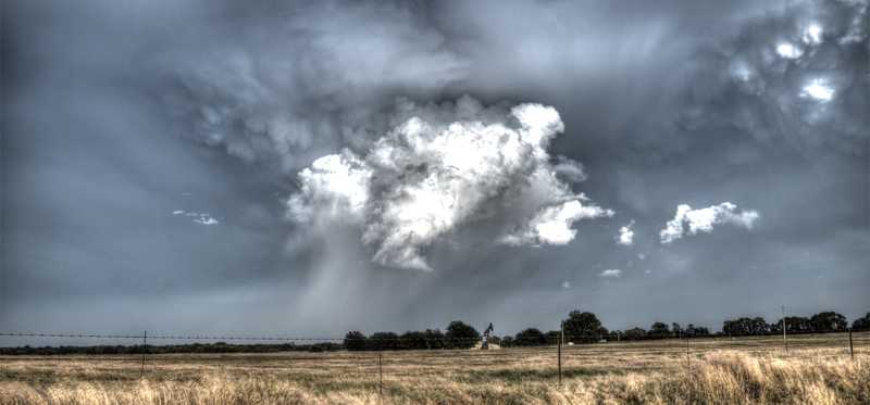 A well in Oklahoma with storm clouds overhead.