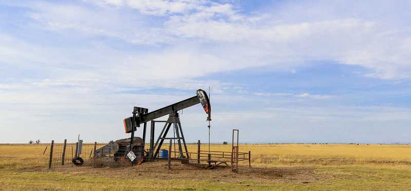 An oil derrick operating on the plains of the Oklahoma panhandle.