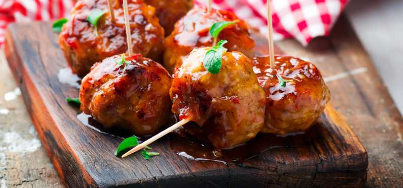 Meatballs sit on a serving slab