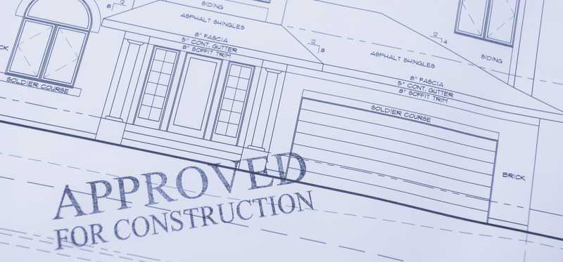 A residential construction blueprint stamped with the words Approved for Construction.