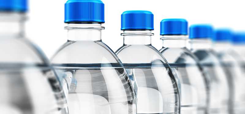 A row of unlabeled bottled water