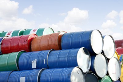 Barrels of crude oil stacked atop one another.