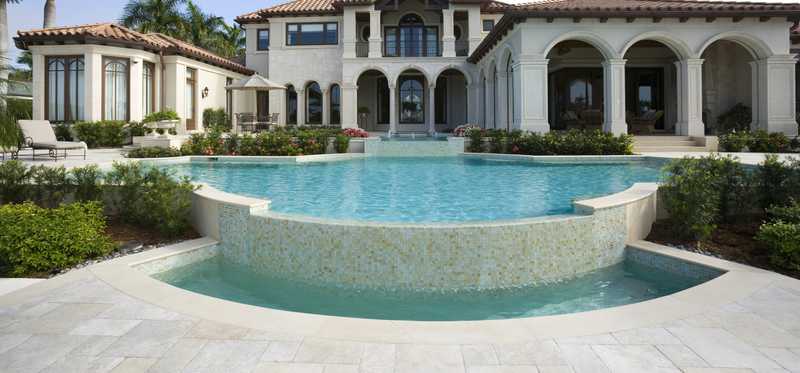 An exterior shot of a large, elegant home in Naples, Florida.