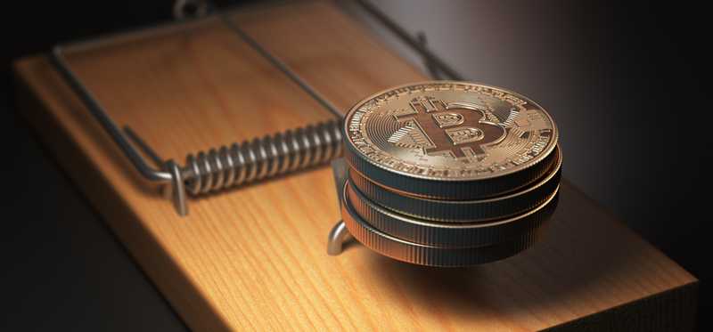 Physical gold coins marked with Bs as the bait on a mousetrap.