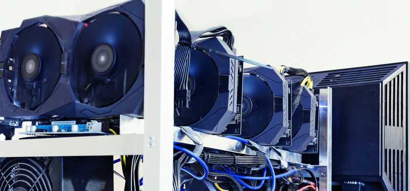 A computer monitor with big hard drives behind it.