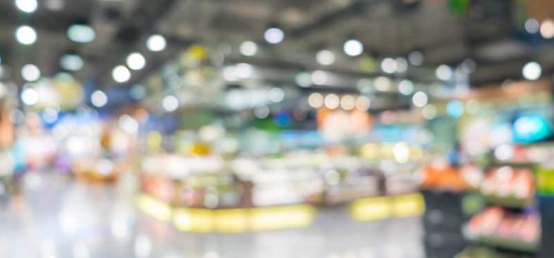 A store is shown in blurred focus.