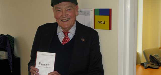 Jack Bogle standing at Fool HQ wearing a Fool hat.
