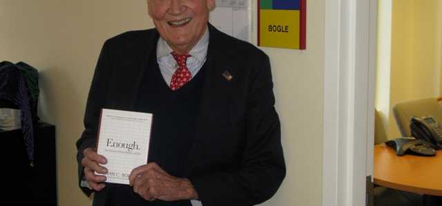 Jack Bogle standing at Fool HQ wearing a Fool hat.