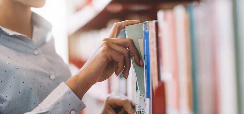 A man is browsing in a bookstore.